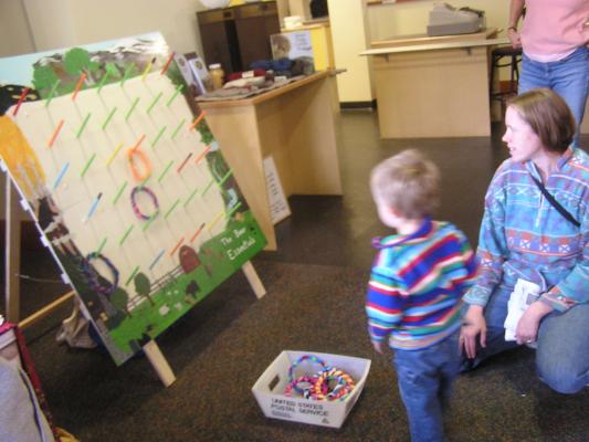 Noah and Katie play a ring-toss game