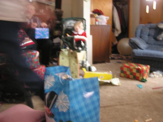 sarah got a xylophon from Santa. She plays in Grandma's stoller.