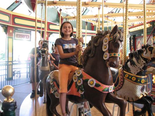 Malia on Carousel horse.