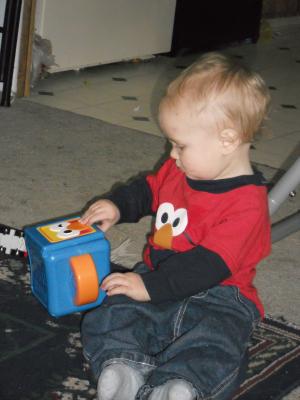 Joshua plays with a birthday gift. 