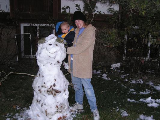Noah and Katie built a snowman in the yard.