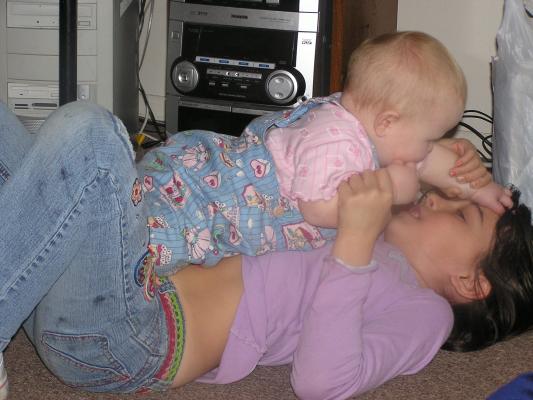 Sarah and Malia play on the floor.