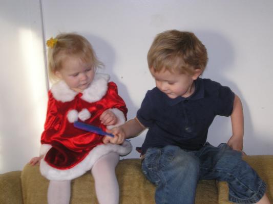 Sarah in her pretty Christmas dress and Noah with a comb.