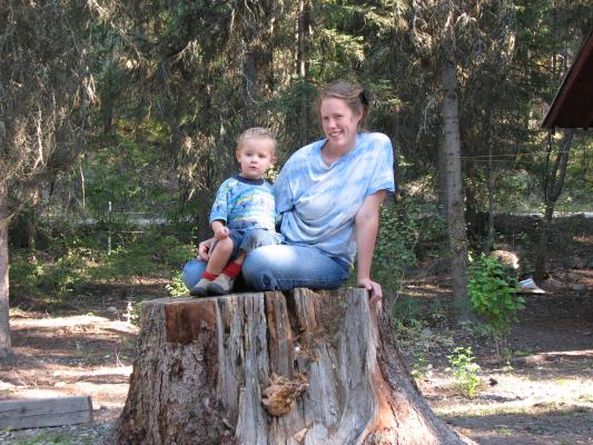 Noah and Katie on a stump at camp