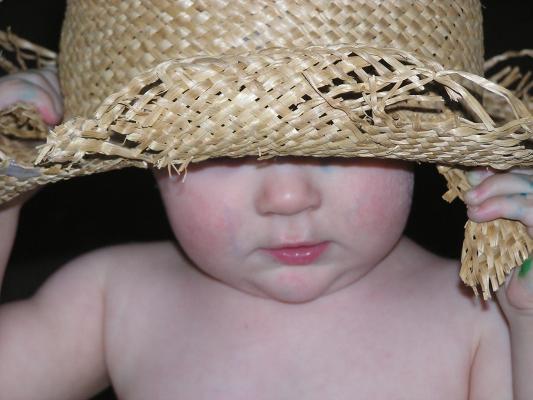 Noah wears an old straw hat.