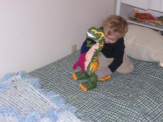 Noah plays with a  dinosaur