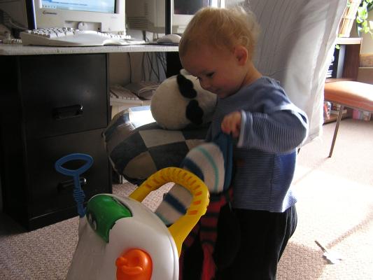 Noah pushes around his penguin.