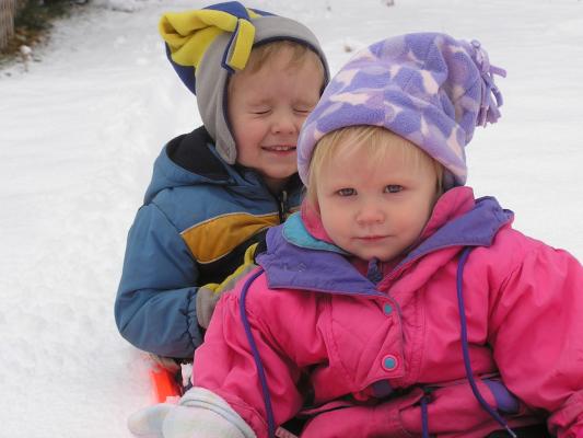 Noah and Sarah ride the sled