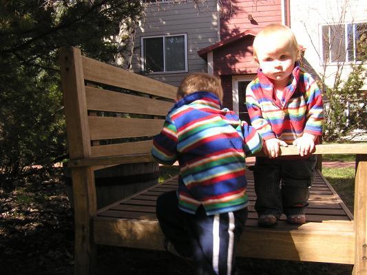 Noah and Sarah climb on the bench.