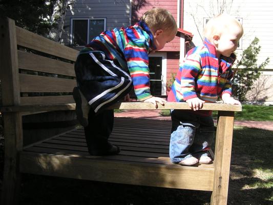 Noah and Sarah climb on the bench.