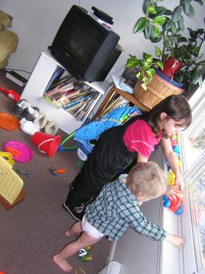 Andrea and Noah play with cars.