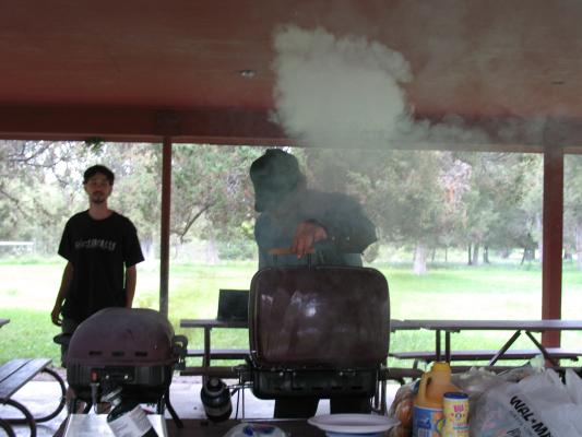 Robert cooks some hamburgers and hotdogs at the Bison Range picnic area.