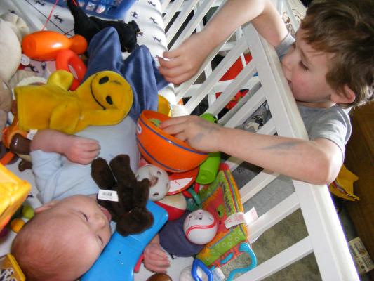 Noah got all the baby toys for Joshua to play with.