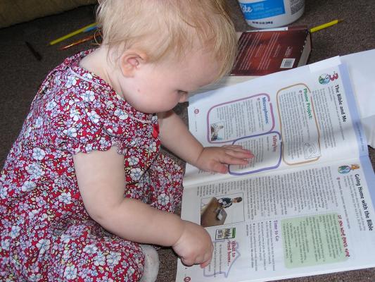 Sarah colors the Sunday School teacher's book.