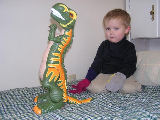 Noah plays with a  dinosaur