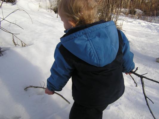 Noah writes letters in the snow.