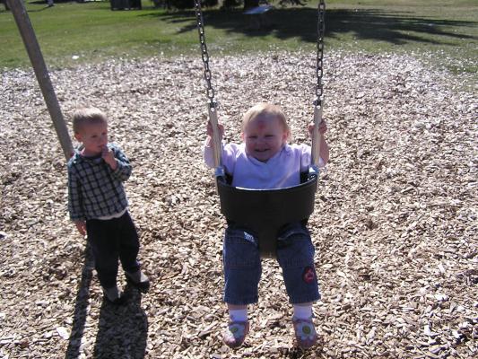 Sarah swings at the park.