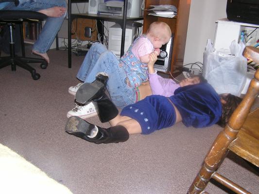 Sarah, Malia, and Andrea play on the floor.