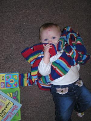 Sarah plays with the sweaters.