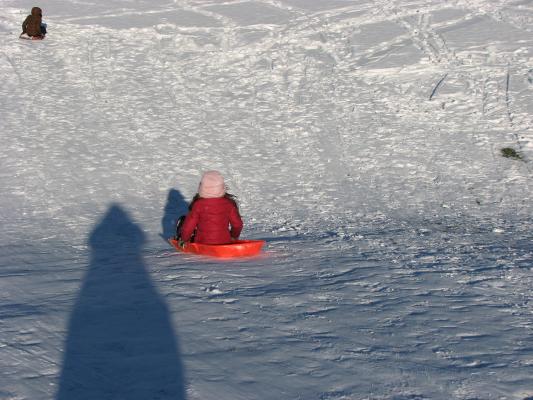 Malia and Andrea sledding.
