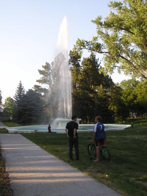 David and Joe talk while Sarah and Noah play in the Fountain