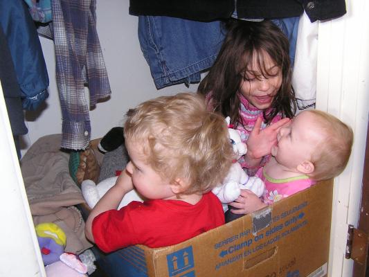 Noah, Andrea and Sarah play in a box of toys.