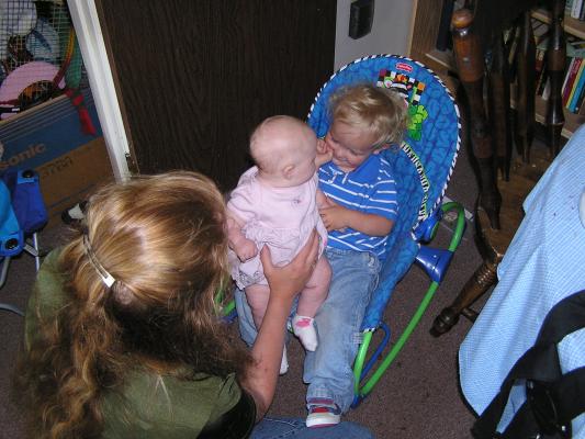 Sarah sits on Noah's lap.