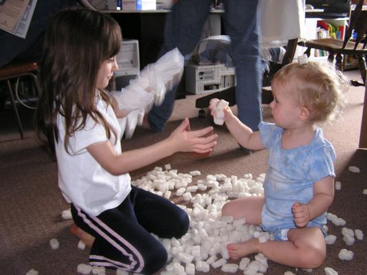Andrea and Noah play with peanuts.