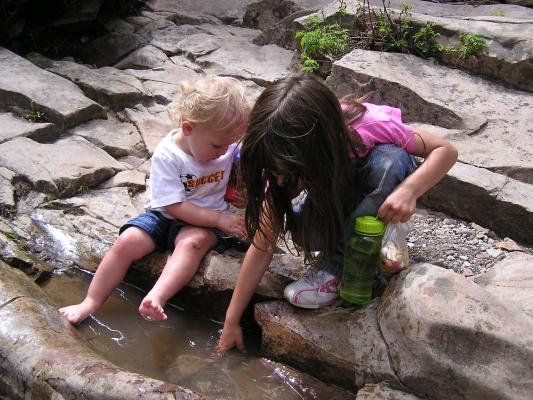 Andrea and Noah play in the little puddles.