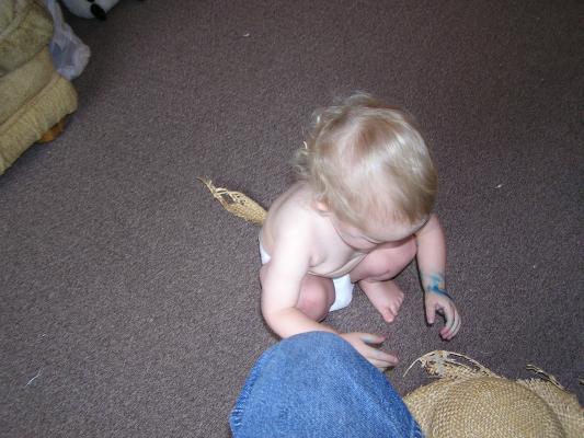 Noah plays with an old straw hat.