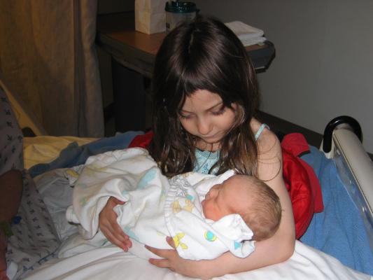 Andrea holds Sarah in the hospital.