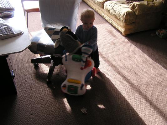 Noah pushes around his penguin.
