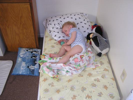 Noah takes a nap on his bed.