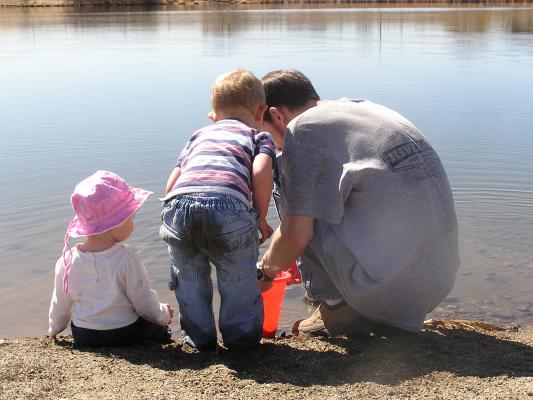 Sarah, Noah and David gather rocks to throw off the dock.