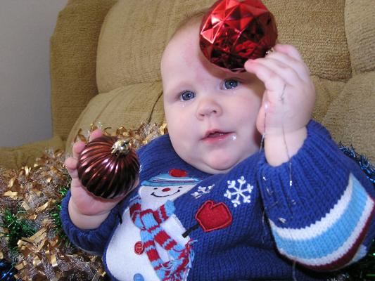 Sarah is shaking two Chriesmas Balls