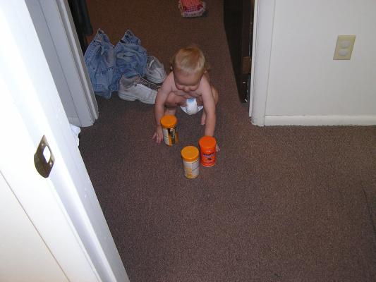 Noah plays with the fish food.