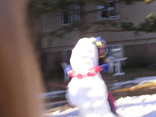 Andrea hugs the snow person.