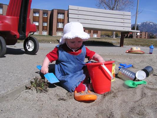 Sarah plays in the sand.
