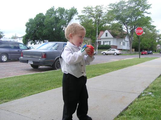 Noah plays with a camera. He has seen many people using cameras latly