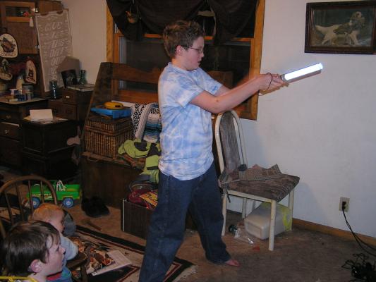 Jedi Joe swings the light saber.