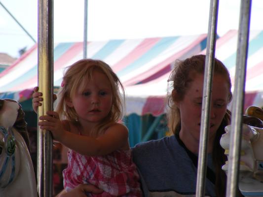 Sarah and Katie ride Carousel horse.