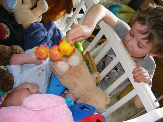 Noah got all the baby toys for Joshua to play with.