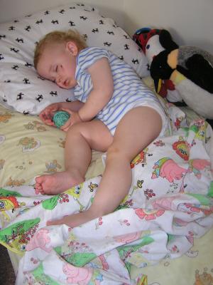 Noah takes a nap on his bed.