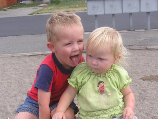 Noah and Sarah on a tire at the park.