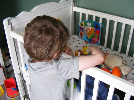 Noah got all the baby toys for Joshua to play with.