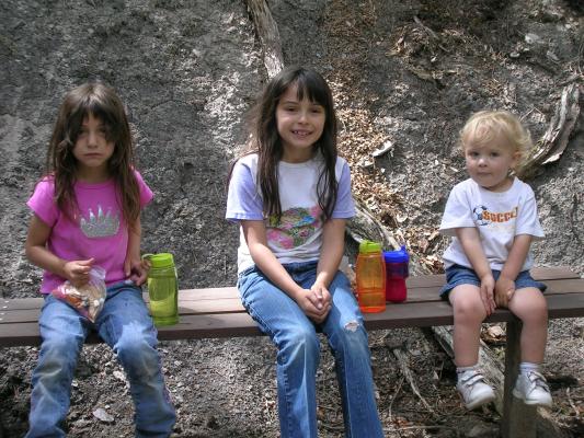 Andrea, Malia and Noah take a break and sit on a bench for a while.