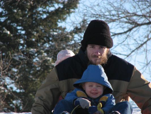 David and Noah go sledding.