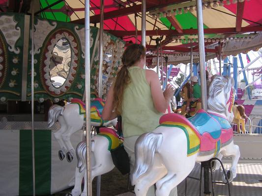 Katie helps Sarah on the carousel