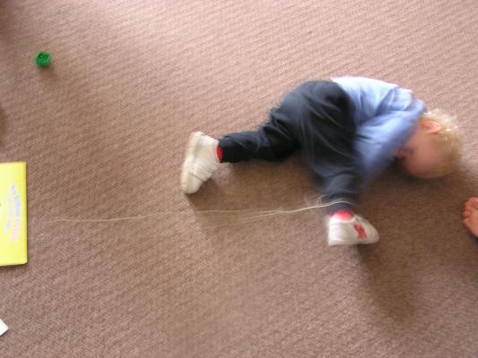 Noah plays on the floor.