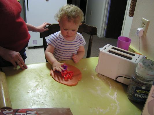 Noah cuts out sugar cookies for Valentines Day.